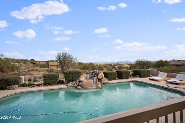 view of pool featuring pool water feature and a patio