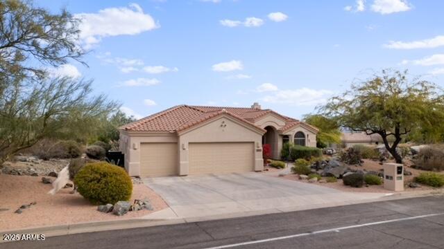 mediterranean / spanish home featuring a garage