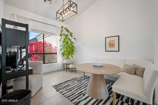 dining room featuring light tile patterned floors, an inviting chandelier, and breakfast area