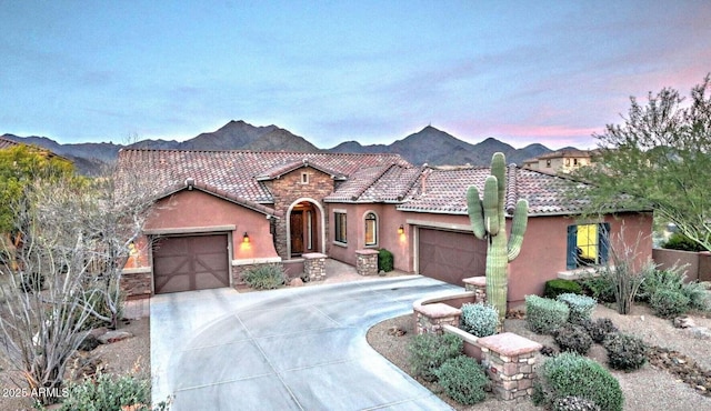 view of front facade featuring a garage and a mountain view