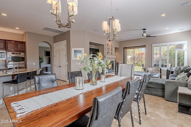 dining space featuring light tile patterned floors and a notable chandelier