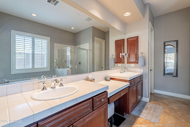 bathroom with vanity and a shower with shower door