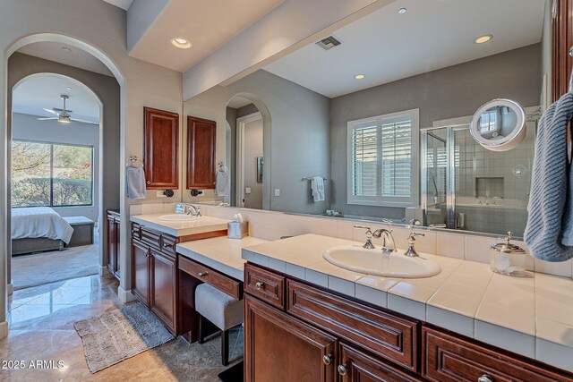 bathroom with an enclosed shower, vanity, a wealth of natural light, and ceiling fan