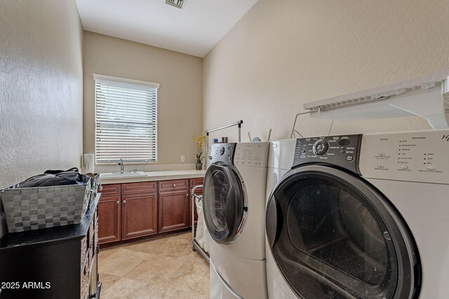 laundry area with cabinets, sink, and washer and dryer