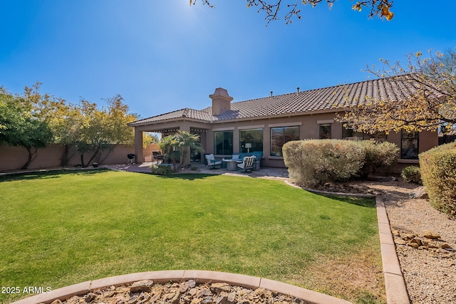 back of house featuring a yard and a patio