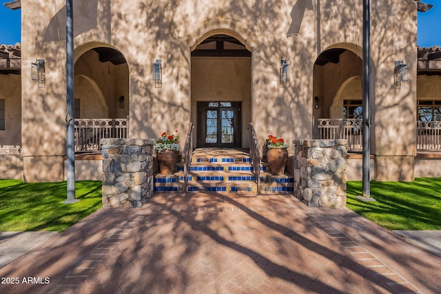 view of exterior entry featuring french doors