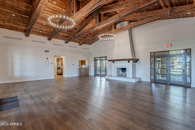 unfurnished living room featuring wood ceiling, a fireplace, dark hardwood / wood-style flooring, french doors, and beamed ceiling