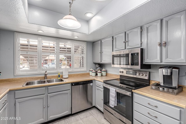 5221 W Garden Dr, Glendale, AZ 85304 - kitchen with gray cabinets, appliances with stainless steel finishes, a sink, and light countertops