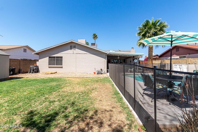 5221 W Garden Dr, Glendale, AZ 85304 - back of property with a fenced in pool, a fenced backyard, a lawn, and ceiling fan
