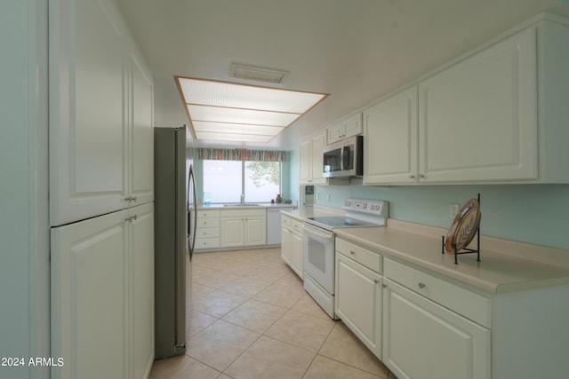 kitchen featuring visible vents, stainless steel appliances, light countertops, white cabinetry, and light tile patterned flooring