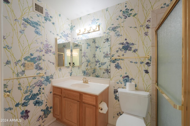 bathroom featuring wallpapered walls, a stall shower, visible vents, toilet, and vanity