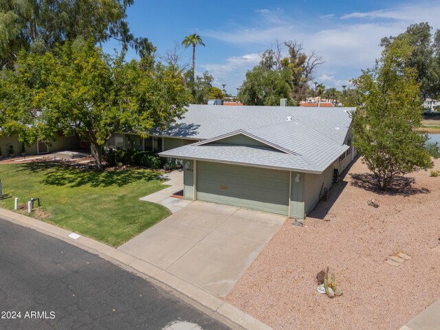 view of front of home featuring a garage and a front lawn