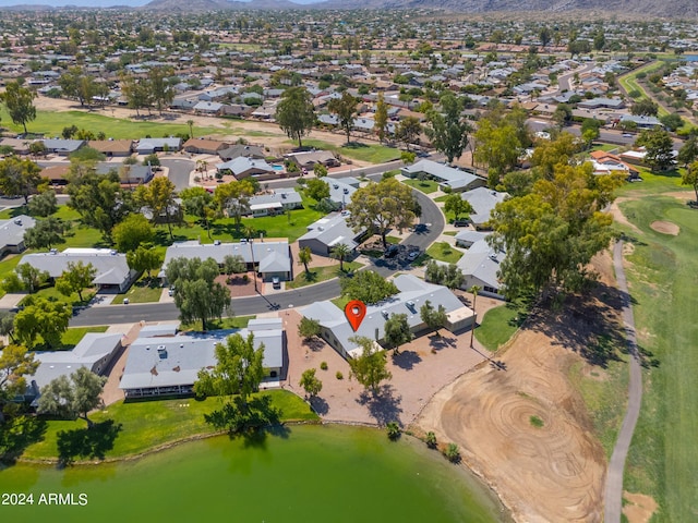 drone / aerial view with a water and mountain view and a residential view