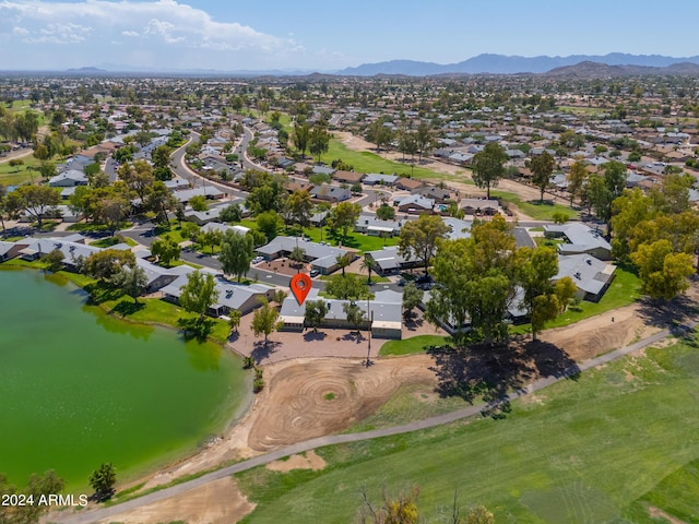 drone / aerial view featuring a water and mountain view and a residential view