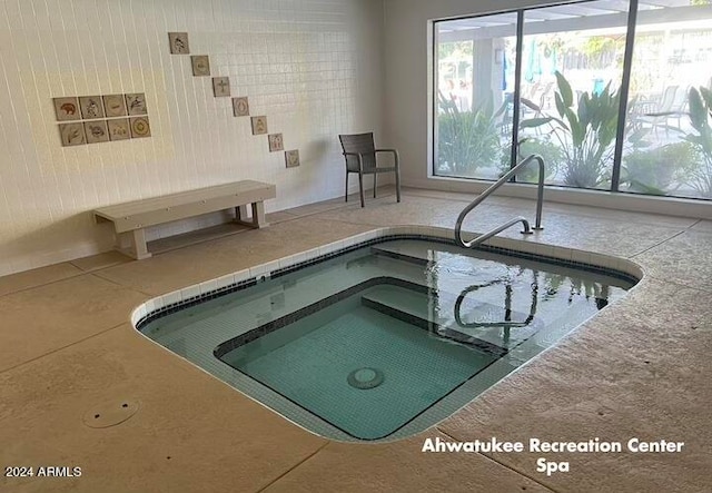 view of swimming pool with an indoor in ground hot tub