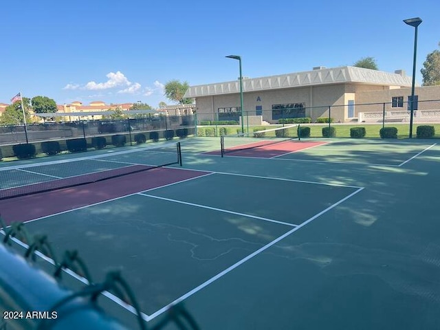 view of tennis court with fence