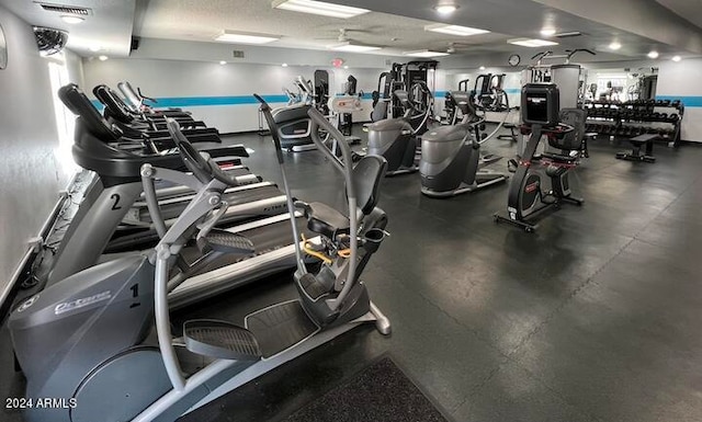 exercise room featuring visible vents and a textured ceiling