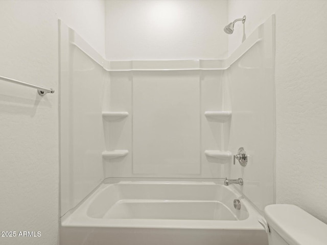 bathroom with toilet and shower / bath combination