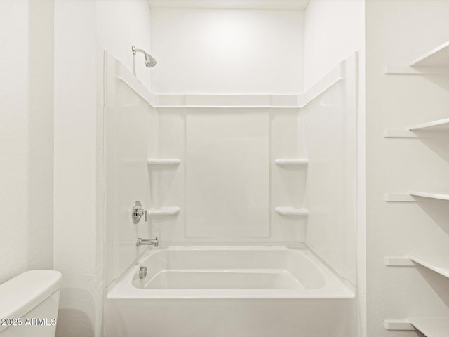 bathroom featuring bathing tub / shower combination and toilet