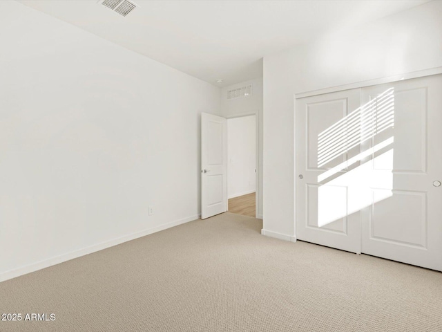 spare room with light colored carpet