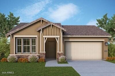 view of front of home with a front yard and a garage