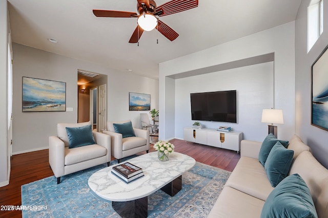 living area with ceiling fan, baseboards, and wood finished floors