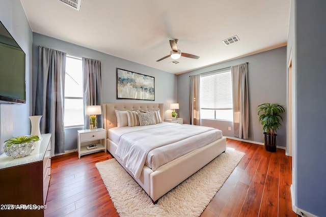 bedroom featuring visible vents, baseboards, and hardwood / wood-style floors