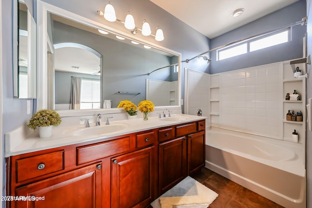 full bath featuring tile patterned floors, shower / bath combination, double vanity, and a sink