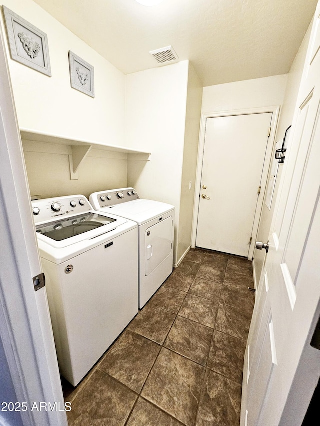 laundry area with washing machine and clothes dryer, laundry area, and visible vents