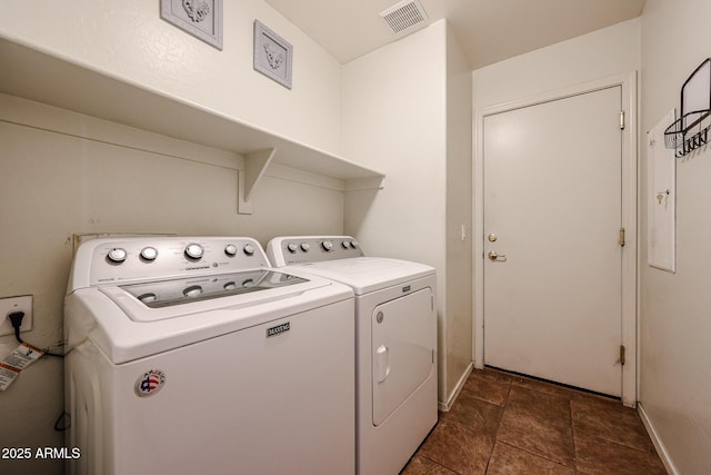 washroom featuring independent washer and dryer, laundry area, baseboards, and visible vents