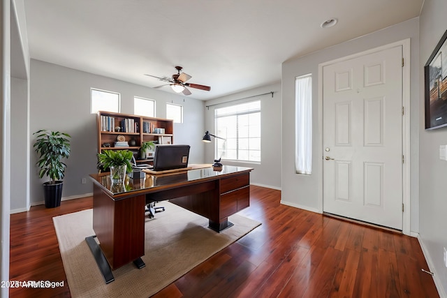 office with dark wood finished floors, a ceiling fan, and baseboards