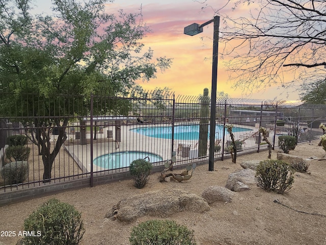 community pool featuring a patio area and fence