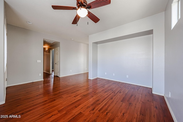 spare room with ceiling fan, baseboards, and wood finished floors