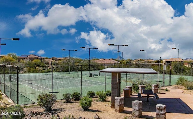 view of tennis court with fence