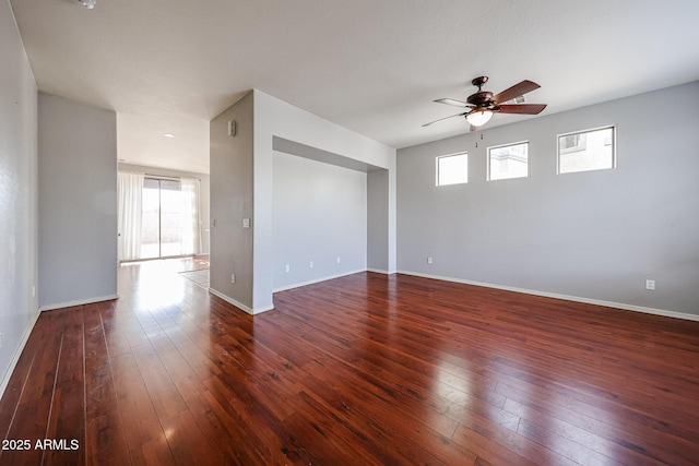 empty room with baseboards, ceiling fan, and hardwood / wood-style flooring