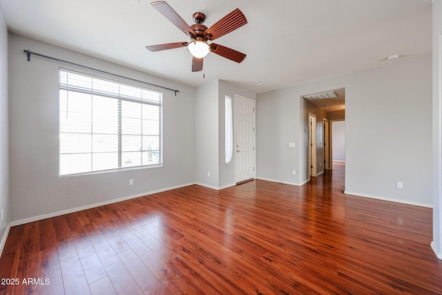 spare room with visible vents, a ceiling fan, baseboards, and hardwood / wood-style floors