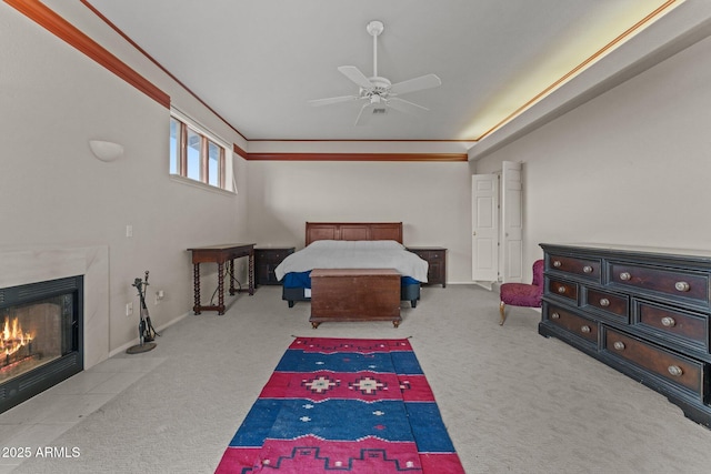 bedroom with ceiling fan, carpet, and a premium fireplace