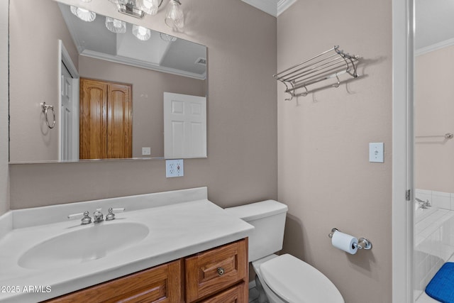 bathroom with vanity, toilet, and ornamental molding