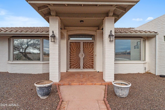 property entrance with a tiled roof