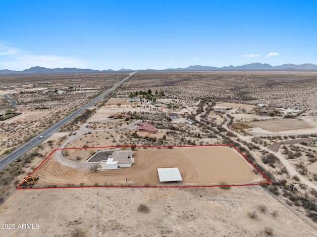 drone / aerial view featuring a rural view, a mountain view, and a desert view