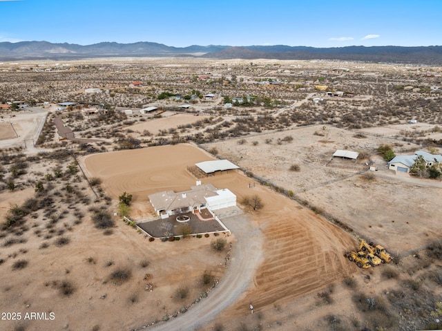 drone / aerial view with a mountain view, a rural view, and view of desert