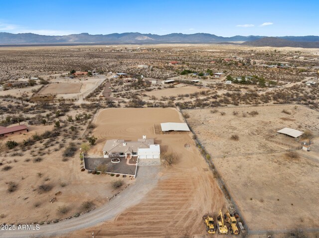 bird's eye view with a mountain view, a rural view, and view of desert