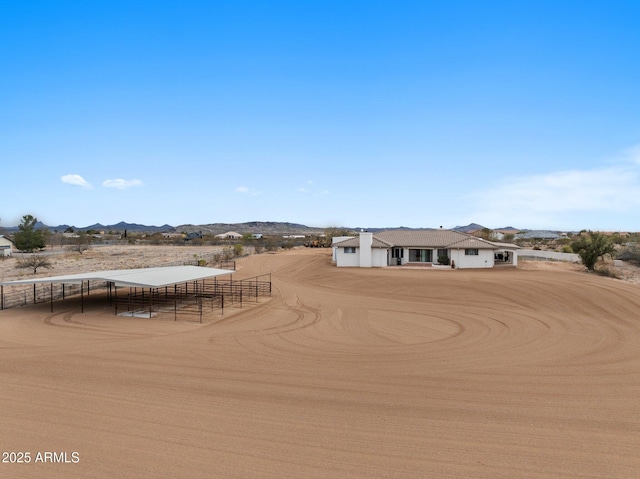 exterior space with a mountain view and fence