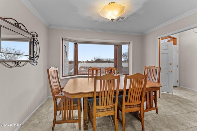 dining space featuring crown molding, light tile patterned flooring, baseboards, and visible vents