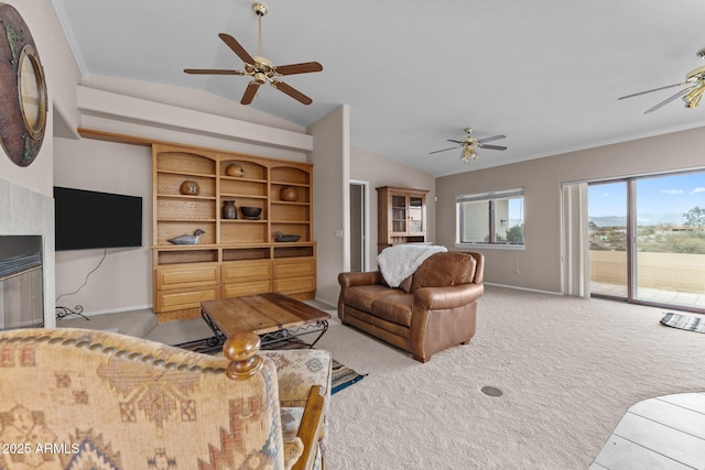 living area featuring a fireplace, baseboards, lofted ceiling, and carpet