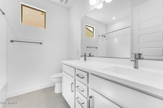 full bath featuring baseboards, toilet, double vanity, and a sink