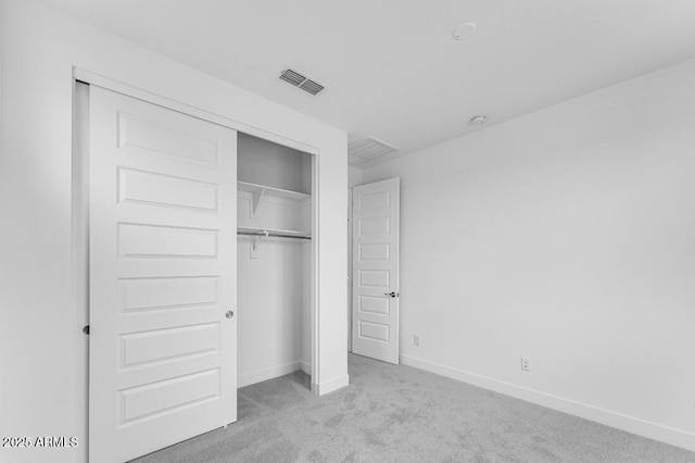 unfurnished bedroom featuring baseboards, visible vents, a closet, and carpet flooring