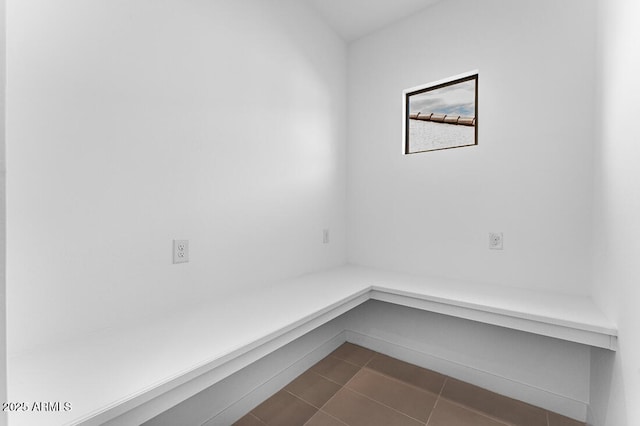 mudroom featuring dark tile patterned floors