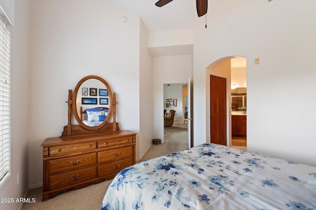11640 N Tatum Blvd Unit 3091, Phoenix, AZ 85028 - bedroom featuring a ceiling fan, arched walkways, ensuite bath, and light carpet