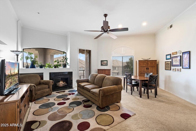 11640 N Tatum Blvd Unit 3091, Phoenix, AZ 85028 - living room with ornamental molding, a ceiling fan, visible vents, carpet floors, and a tiled fireplace